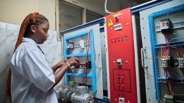 Technician wiring an electrical control panel