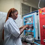 Technician wiring an electrical control panel